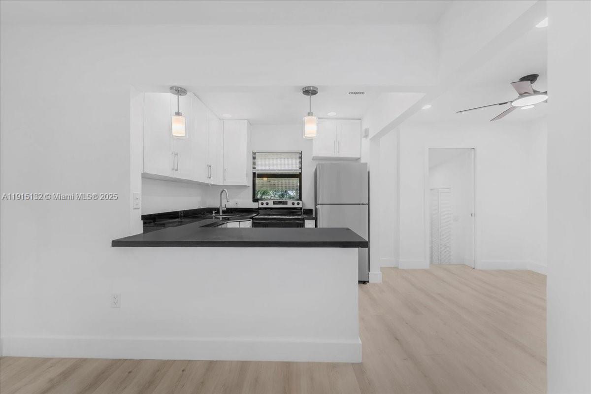 5220 Southwest 6th Street Miami, FL 33134 - Photo 26 of 56 a kitchen with stainless steel appliances granite countertop a sink and a stove