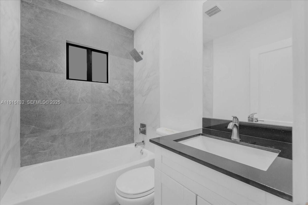 5220 Southwest 6th Street Miami, FL 33134 - Photo 33 of 56 a bathroom with a granite countertop sink toilet and bathtub