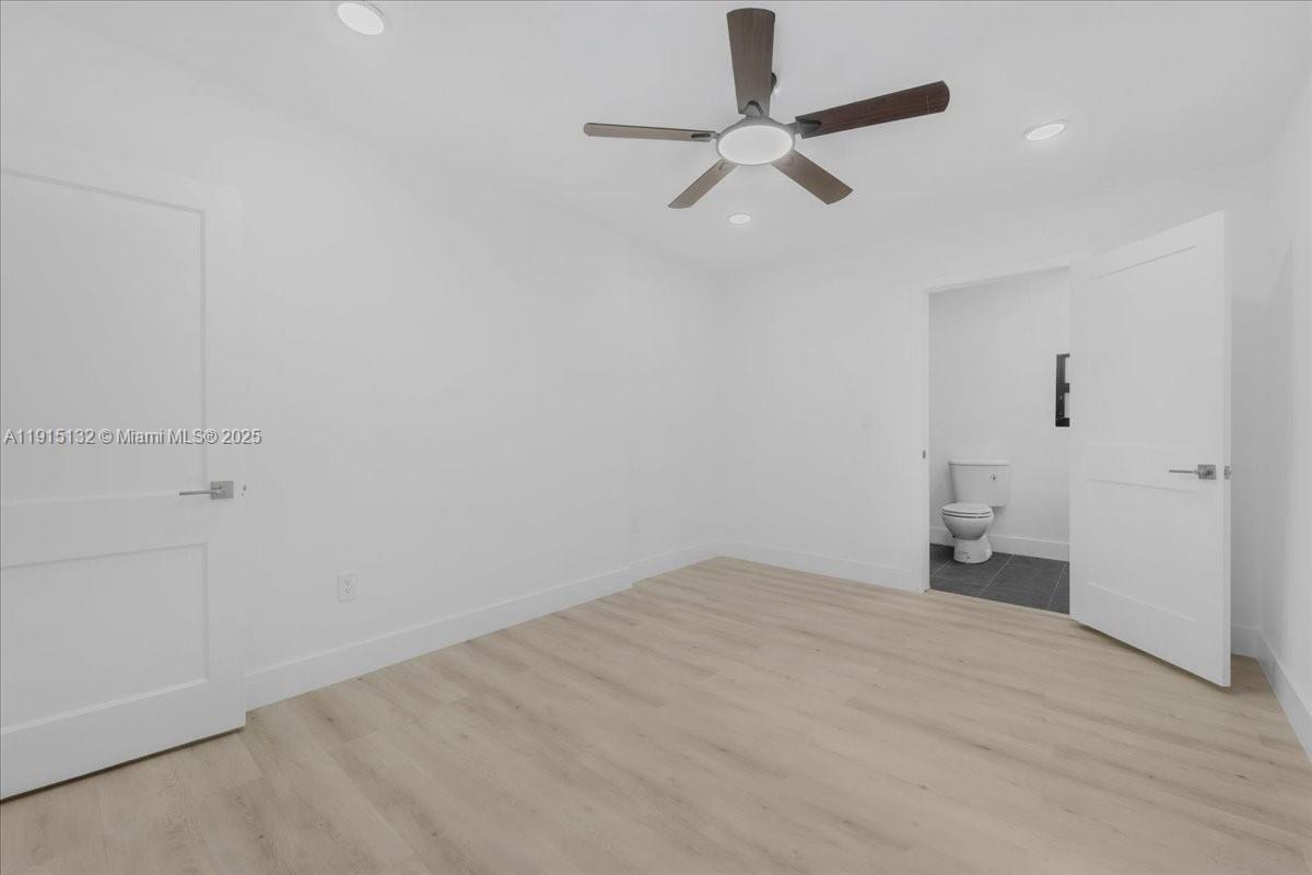 5220 Southwest 6th Street Miami, FL 33134 - Photo 37 of 56 an empty room with a ceiling fan and window