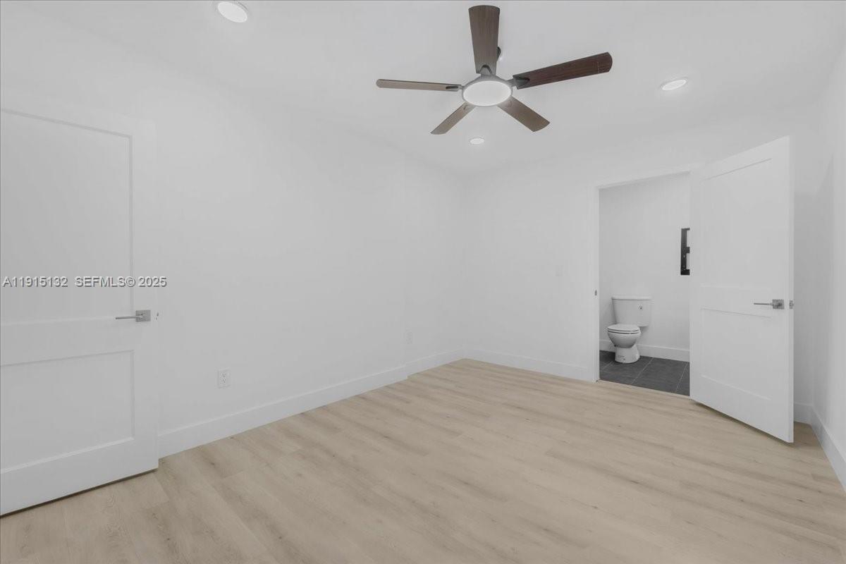 5220 Southwest 6th Street Miami, FL 33134 - Photo 37 of 56 an empty room with a ceiling fan and window