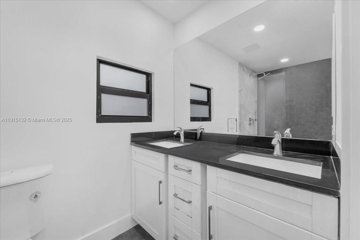 5220 Southwest 6th Street Miami, FL 33134 - Photo 39 of 56 a bathroom with a granite countertop sink and a mirror