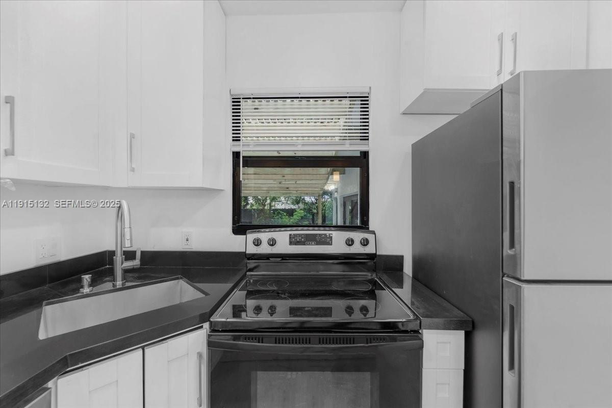 5220 Southwest 6th Street Miami, FL 33134 - Photo 45 of 56 a kitchen with a stove and a refrigerator