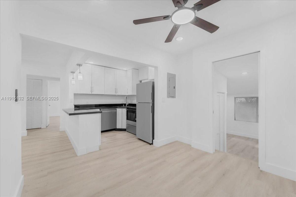 5220 Southwest 6th Street Miami, FL 33134 - Photo 49 of 56 a open kitchen with white cabinets and stainless steel appliances