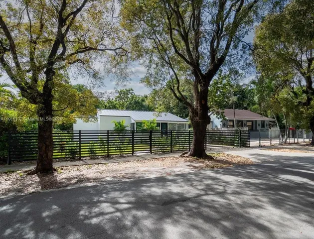 a view of a house with a tree in the yard