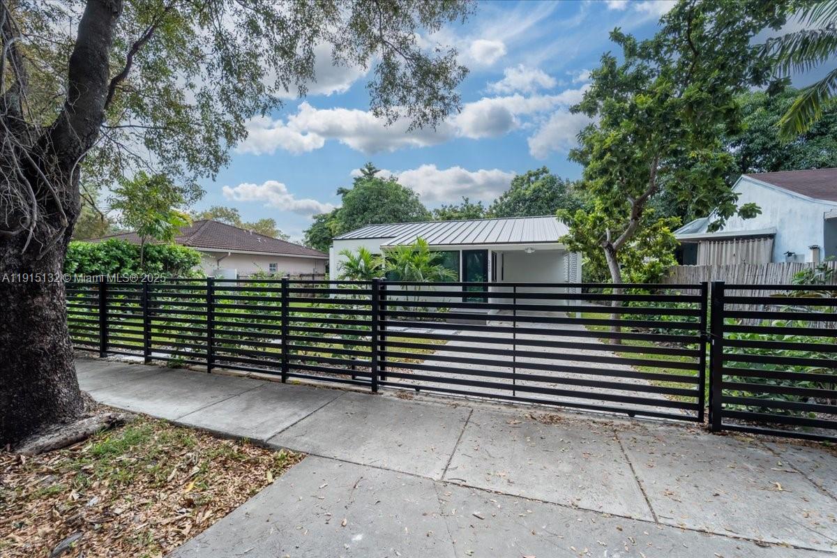 5220 Southwest 6th Street Miami, FL 33134 - Photo 9 of 56 a view of a brick house with many windows