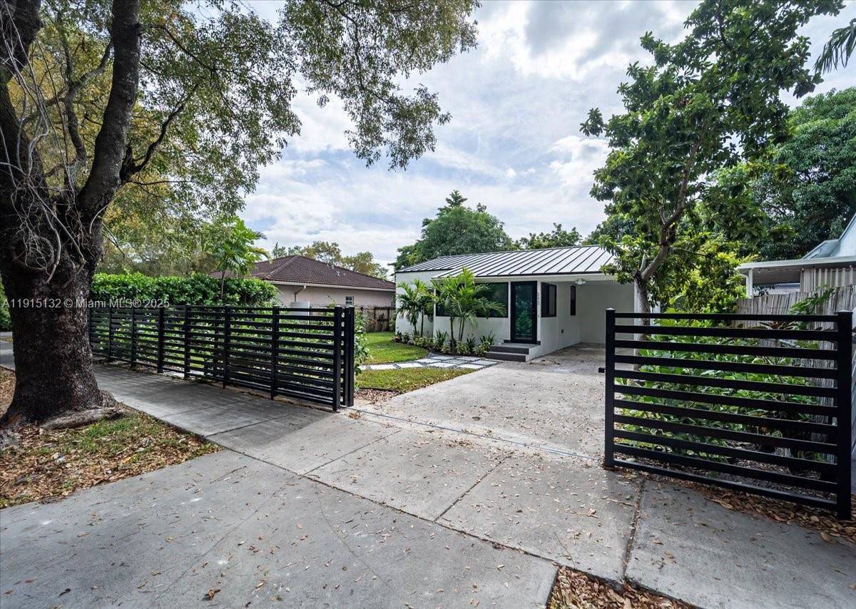 5220 Southwest 6th Street Miami, FL 33134 - Photo 10 of 56 a view of house with backyard and a garden