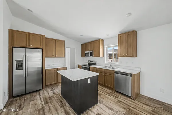 a kitchen with a sink stove and refrigerator