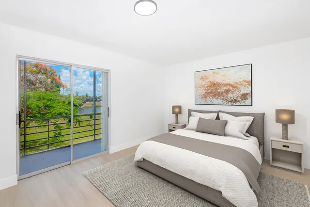 a bedroom with a bed and a painting on the wall