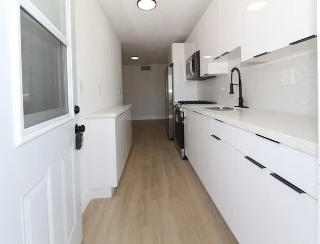 a kitchen with a sink and refrigerator