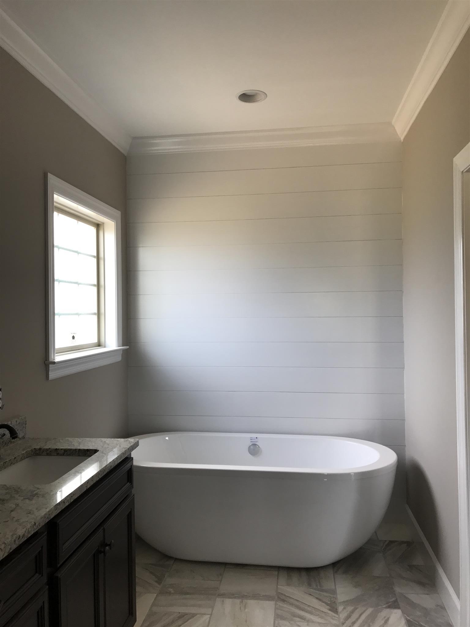 479 Halltown Road Portland, TN 37148 - Photo 16 of 25 a bathroom with a bathtub and window