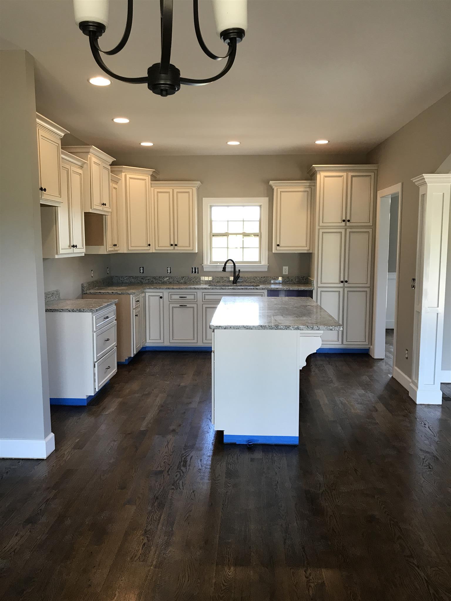 479 Halltown Road Portland, TN 37148 - Photo 5 of 25 a kitchen with stainless steel appliances granite countertop a sink a stove a refrigerator cabinets and a dining table