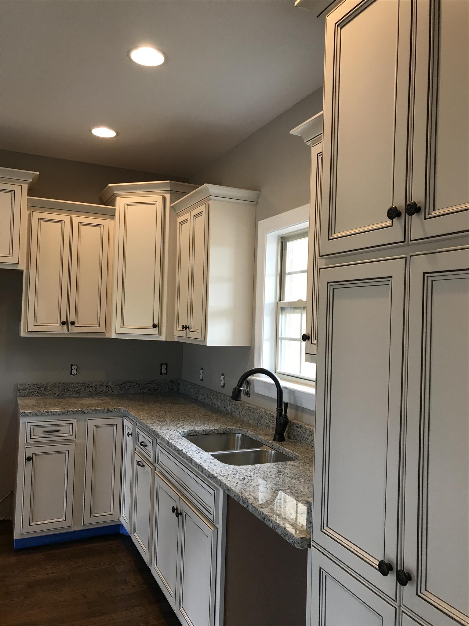479 Halltown Road Portland, TN 37148 - Photo 6 of 25 a kitchen with granite countertop a sink and cabinets