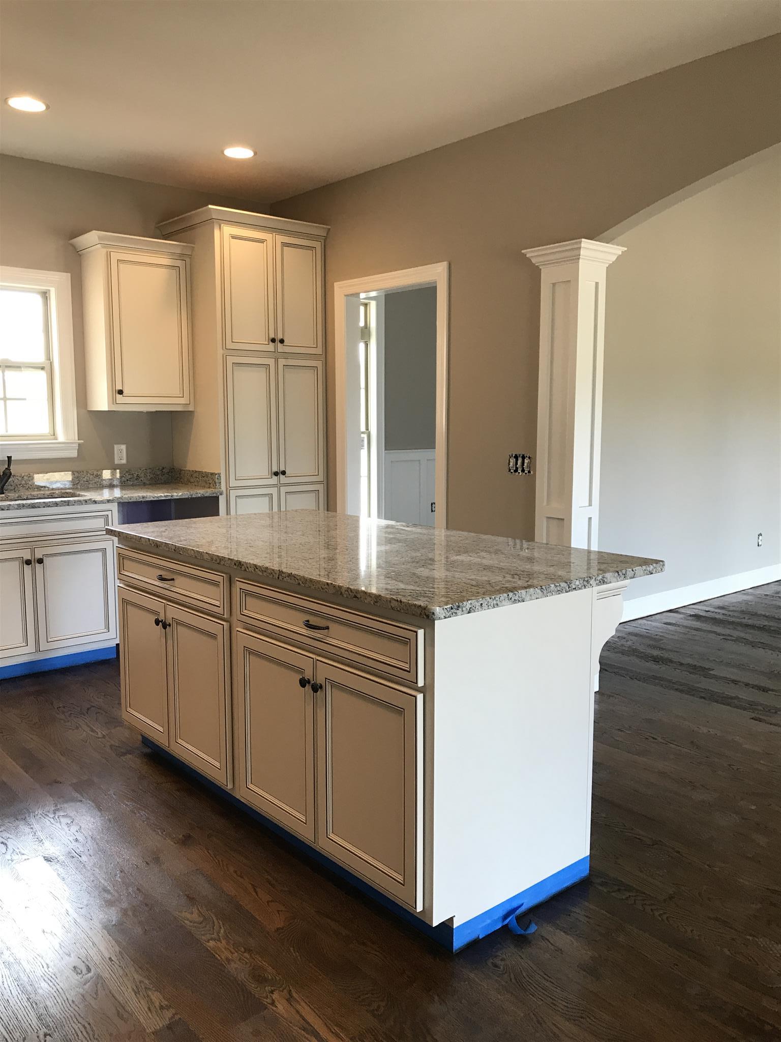 479 Halltown Road Portland, TN 37148 - Photo 7 of 25 a kitchen with stainless steel appliances granite countertop a stove a sink and white cabinets