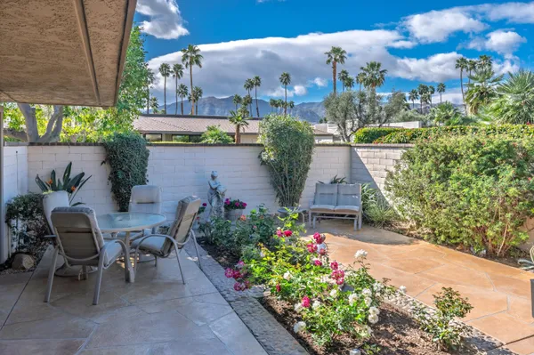a view of a patio in a backyard