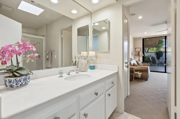 a en suite bathroom with a sink double vanity and mirror