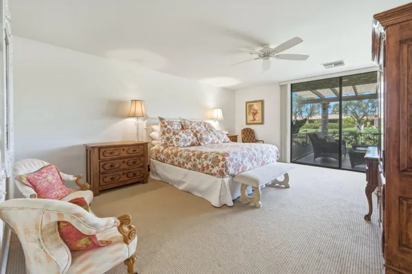 a bed room with a bed and a chair
