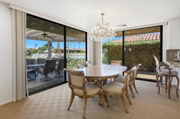 a view of a dining room with furniture window and outside view