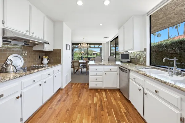 a kitchen with cabinets oven stove top oven and sink