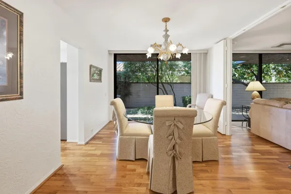 a view of a dining room with furniture wooden floor and chandelier