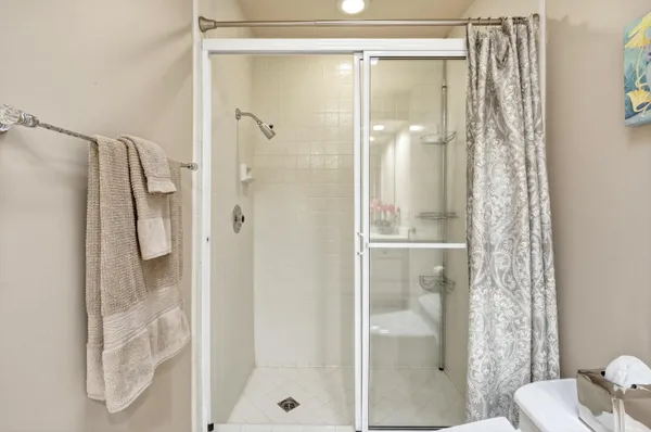 a bathroom with a glass shower door and a toilet