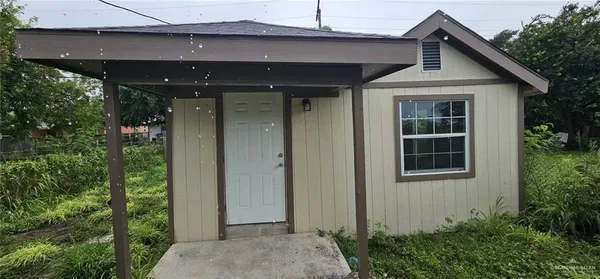a front view of a house with a yard garage and outdoor seating