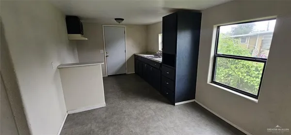 a kitchen with a refrigerator and a window
