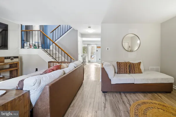 a living room with furniture and wooden floor