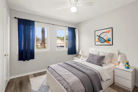 a bedroom with a bed and a painting on the wall