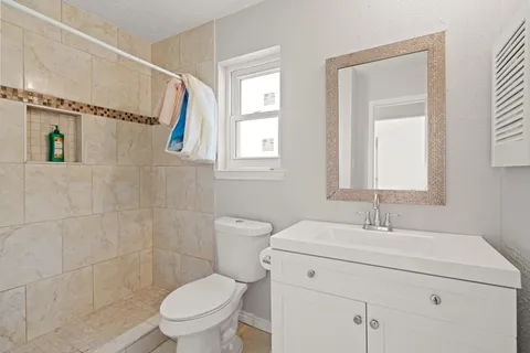 a bathroom with a sink toilet and shower