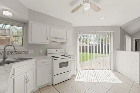 a kitchen with a stove a sink and a microwave