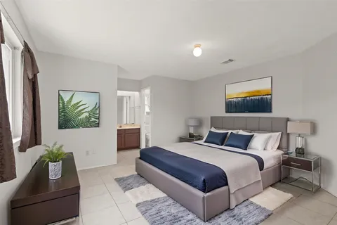 a bedroom with bed and a couch