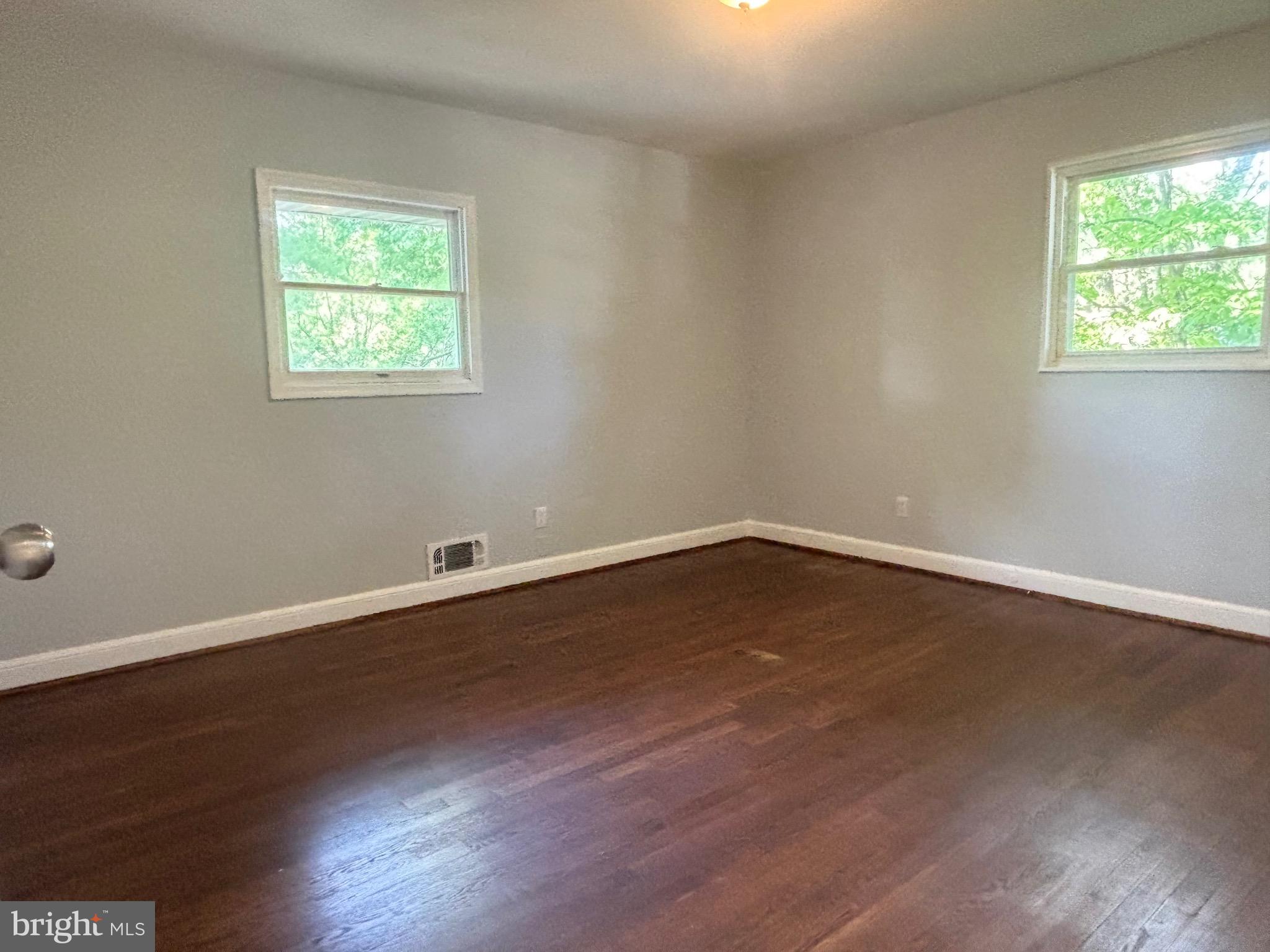 9103 Wallace Road Lanham, MD 20706 - Photo 12 of 30 a view of a room with wooden floor and windows in it