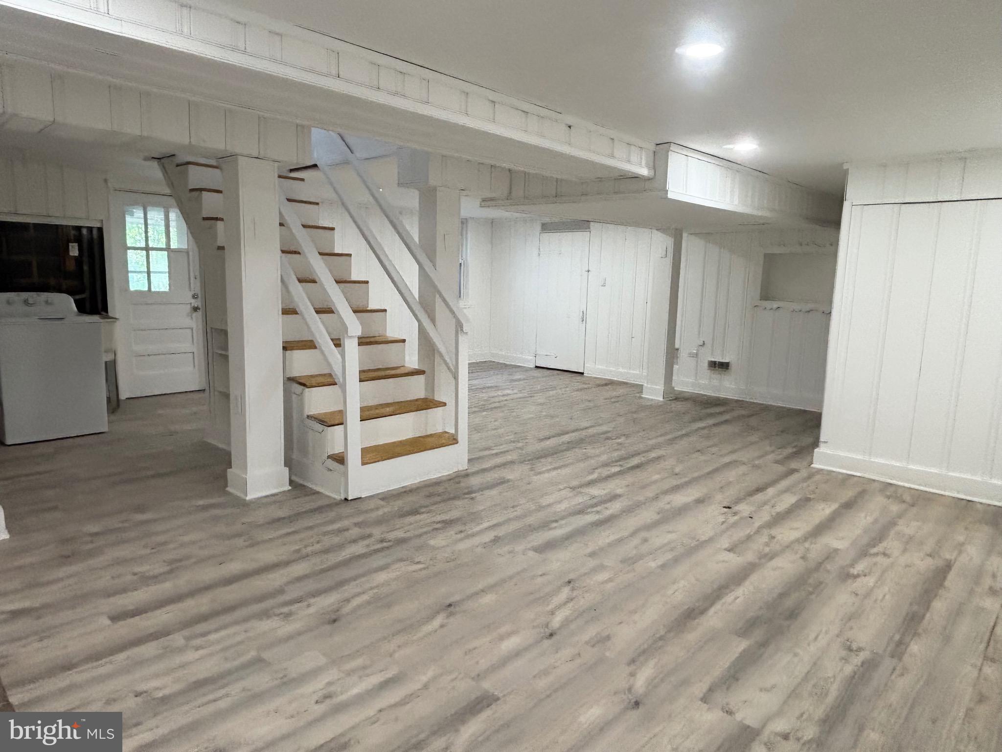 9103 Wallace Road Lanham, MD 20706 - Photo 16 of 30 an empty room with wooden floor and windows
