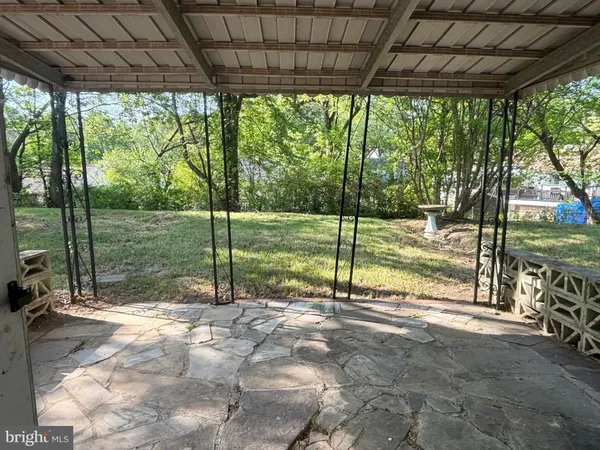 a view of a backyard with floor to ceiling windows and a table