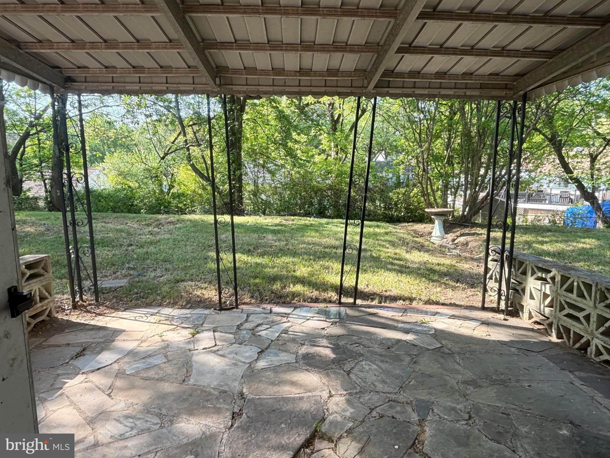 9103 Wallace Road Lanham, MD 20706 - Photo 26 of 30 a view of a backyard with floor to ceiling windows and a table