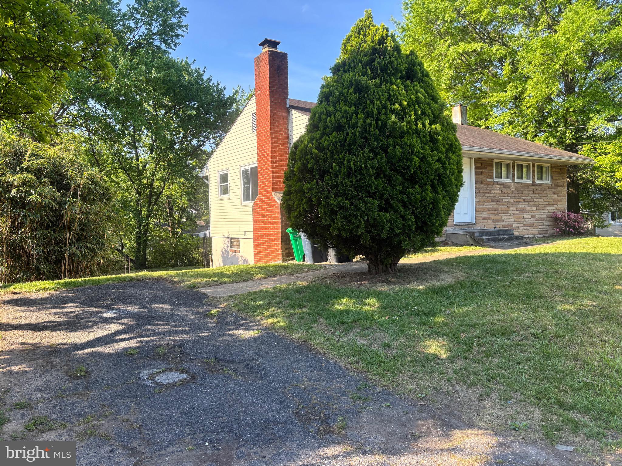 9103 Wallace Road Lanham, MD 20706 - Photo 27 of 30 a view of a house with a yard and large tree