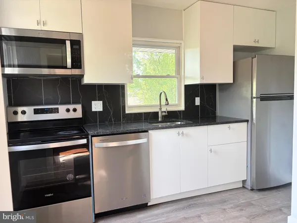 a kitchen with a refrigerator stove and microwave