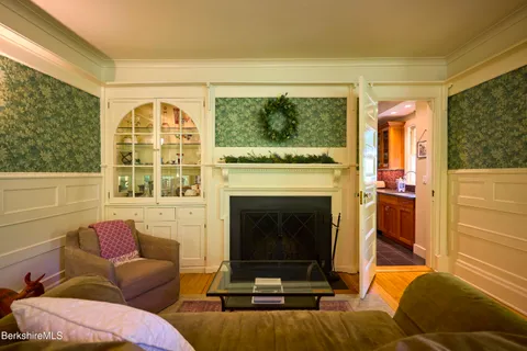 a living room with furniture and large windows