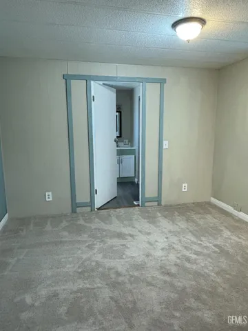 a view of an empty room and closet