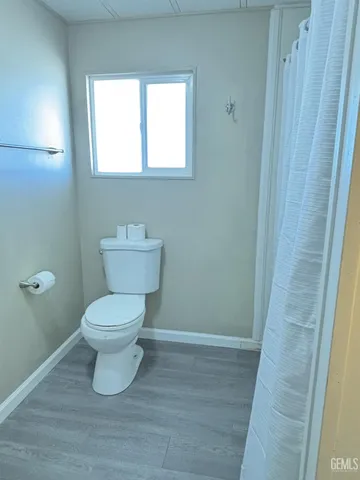a white toilet sitting next to a small sink