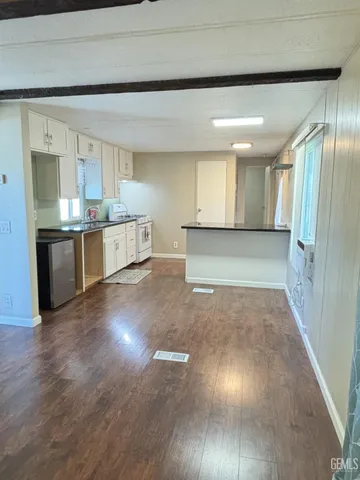 a view of a kitchen cabinets and wooden floor