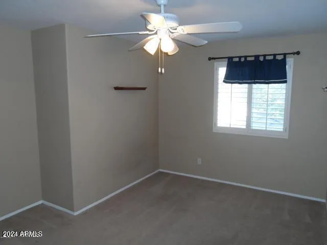 a view of room with window and ceiling fan