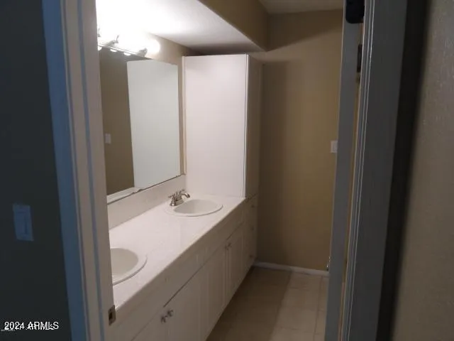 a bathroom with a double vanity sink and a mirror