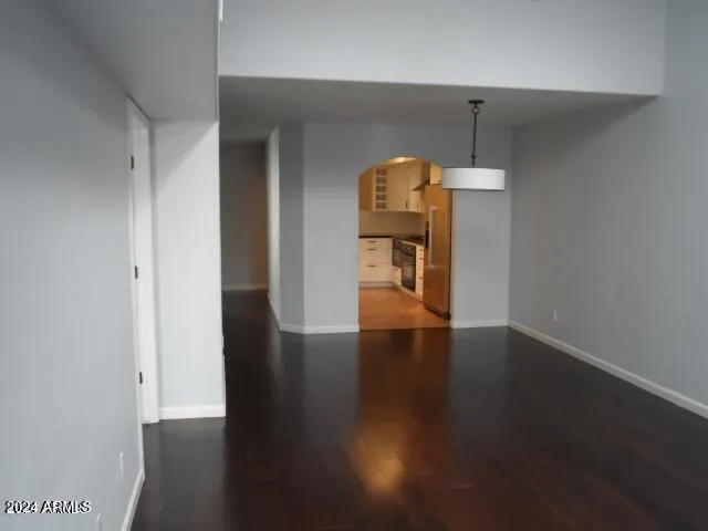 an empty room with wooden floor and a window
