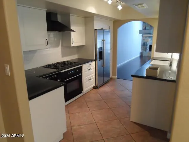a kitchen with a stove top oven and cabinets