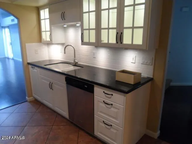 a kitchen with granite countertop a sink and a window