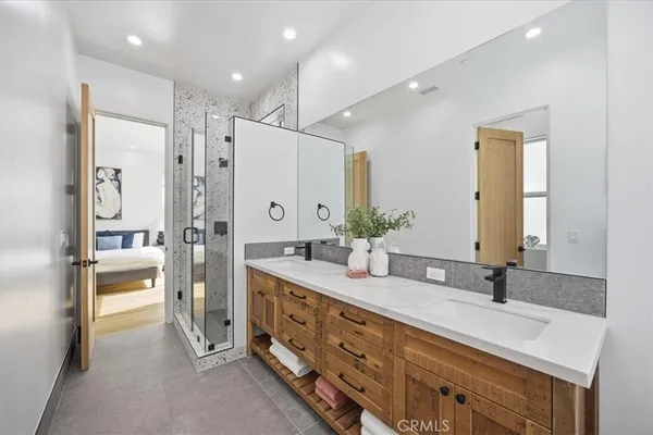 a spacious bathroom with a double vanity sink shower and a mirror