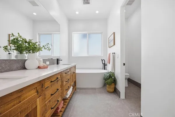 a bathroom with a double vanity sink and a mirror