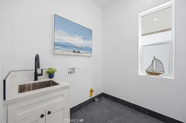 a room with a painting on the wall and a window