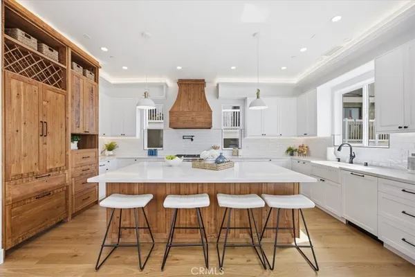 a kitchen with stainless steel appliances kitchen island granite countertop a sink and cabinets